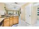 Kitchen with granite countertops, tile floor, and view of the living area at 8932 Village Green Blvd, Clermont, FL 34711