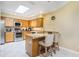 Bright eat-in kitchen with stainless steel appliances, granite counters, and breakfast bar at 8932 Village Green Blvd, Clermont, FL 34711