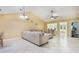 Open-concept living space with tile flooring, neutral color palette, and lots of natural light at 8932 Village Green Blvd, Clermont, FL 34711