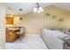 Open-concept kitchen and living room featuring tiled floors and neutral tones at 8932 Village Green Blvd, Clermont, FL 34711