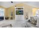 Comfortable living room with built-in shelving, tile flooring, and neutral decor at 8932 Village Green Blvd, Clermont, FL 34711