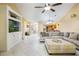 Cozy living room featuring a built-in entertainment center and comfortable seating at 8932 Village Green Blvd, Clermont, FL 34711
