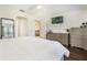 Spacious main bedroom with hardwood floors and neutral-colored furnishings at 8932 Village Green Blvd, Clermont, FL 34711
