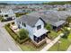 Aerial view showcases the home's manicured lawn and cozy outdoor patio with white umbrella and stylish seating area at 9201 Smithies St, Orlando, FL 32827
