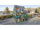 Modern art on display by the lake features a colorful glass house with eye-catching geometric design at 9201 Smithies St, Orlando, FL 32827