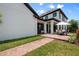 Spacious backyard featuring a paved patio, manicured lawn, and elegant home exterior at 9201 Smithies St, Orlando, FL 32827