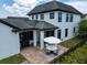 A charming backyard patio includes a BBQ grill and patio set, perfect for outdoor dining and entertaining at 9201 Smithies St, Orlando, FL 32827