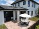 A charming backyard patio includes a BBQ grill and patio set, perfect for outdoor dining and entertaining at 9201 Smithies St, Orlando, FL 32827