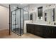 Beautiful bathroom featuring double sinks with gold hardware and a large glass shower at 9201 Smithies St, Orlando, FL 32827