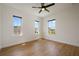 Bright bedroom with three windows, providing lots of natural light, and sleek flooring at 9201 Smithies St, Orlando, FL 32827