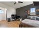 Modern bedroom featuring a black accent wall, light hardwood floors, and a view of the backyard at 9201 Smithies St, Orlando, FL 32827