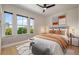 Bright bedroom featuring stylish decor and three large windows offering views of the green landscape at 9201 Smithies St, Orlando, FL 32827
