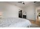 Bright bedroom with white walls, a ceiling fan, and view of a modern mirror with a black frame at 9201 Smithies St, Orlando, FL 32827