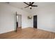 Open bedroom with sleek flooring, a modern ceiling fan and neutral walls and black doors at 9201 Smithies St, Orlando, FL 32827