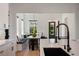 A kitchen with a long island overlooking an open dining and living area with seating at 9201 Smithies St, Orlando, FL 32827