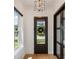 Bright entryway with a stylish light fixture and view of the front yard at 9201 Smithies St, Orlando, FL 32827