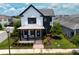 Beautiful two-story home with a stylish front porch, manicured lawn, and lush landscaping at 9201 Smithies St, Orlando, FL 32827