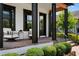 Inviting front porch with seating, brick steps, and black accents at 9201 Smithies St, Orlando, FL 32827