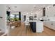 Open concept kitchen with a large island, stainless steel appliances, and a seamless flow to the living room at 9201 Smithies St, Orlando, FL 32827