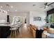 The living room boasts wood floors, a modern sofa, stylish decor, and seamlessly connects to the open-concept kitchen at 9201 Smithies St, Orlando, FL 32827