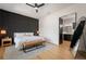 This main bedroom features a unique accent wall, ample natural light, and an adjoining bathroom for convenience at 9201 Smithies St, Orlando, FL 32827