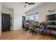 Office featuring sleek flooring, three windows, neutral walls, and multiple desks at 9201 Smithies St, Orlando, FL 32827