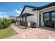 A cozy outdoor kitchen featuring a built-in grill, bar seating, and elegant lighting at 9201 Smithies St, Orlando, FL 32827