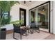 The covered patio features brick flooring and a comfortable seating area with modern decor at 9201 Smithies St, Orlando, FL 32827