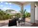 An outdoor dining area featuring a table with an umbrella and manicured landscaping at 9201 Smithies St, Orlando, FL 32827