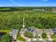 Beautiful aerial view of a home backing to a lush green forest and a distant lake in the community at 9454 Candice Ct, Orlando, FL 32832