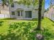 View of a spacious backyard featuring a patio, lawn, and tree at 9454 Candice Ct, Orlando, FL 32832