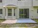 The home's backyard features a small patio, sliding glass door, and a bay window at 9454 Candice Ct, Orlando, FL 32832