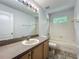 A bathroom features a large mirror, vanity, toilet, and a shower and tub combination at 9454 Candice Ct, Orlando, FL 32832