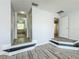 A primary bedroom with hardwood flooring and steps to the bathroom and closet at 9454 Candice Ct, Orlando, FL 32832