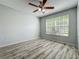 Bedroom featuring natural light from the window, ceiling fan, and wood-look flooring at 9454 Candice Ct, Orlando, FL 32832