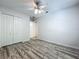 Bedroom featuring wood-look flooring, closet, and a ceiling fan for comfortable living at 9454 Candice Ct, Orlando, FL 32832