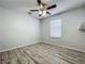 Empty bedroom with wood-look flooring, a ceiling fan, and a bright window at 9454 Candice Ct, Orlando, FL 32832