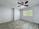 Bedroom featuring wood-look floors, a ceiling fan, and a bright window at 9454 Candice Ct, Orlando, FL 32832