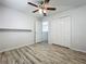 Neutral bedroom with ceiling fan, closet, and a door leading to another room at 9454 Candice Ct, Orlando, FL 32832