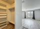 A walk-in closet features built-in shelving and a rod for hanging clothes at 9454 Candice Ct, Orlando, FL 32832