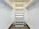 A walk-in closet with shelving and rods for hanging clothes and storing belongings at 9454 Candice Ct, Orlando, FL 32832