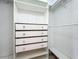 A walk-in closet features a built-in storage unit with drawers and shelving at 9454 Candice Ct, Orlando, FL 32832