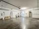 Spacious garage featuring white walls, concrete flooring, and additional storage areas at 9454 Candice Ct, Orlando, FL 32832