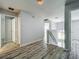 Open upstairs hallway with wood-look floors and natural light from a nearby window at 9454 Candice Ct, Orlando, FL 32832