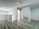 Bright hallway featuring modern floors and a view of a bedroom with a chandelier at 9454 Candice Ct, Orlando, FL 32832