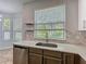 Modern kitchen featuring light countertops, mosaic backsplash, stainless steel appliances, and natural lighting at 9454 Candice Ct, Orlando, FL 32832