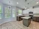 Charming kitchen featuring a center island, mosaic backsplash, stainless steel appliances, and ample cabinet space at 9454 Candice Ct, Orlando, FL 32832