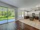 Modern kitchen with stainless appliances, granite countertops, backsplash and sliding glass doors to outdoor patio at 9454 Candice Ct, Orlando, FL 32832
