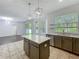 Bright kitchen featuring a center island, mosaic backsplash, stainless steel appliances, and open layout at 9454 Candice Ct, Orlando, FL 32832