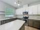 Bright kitchen with stainless steel appliances, a center island, mosaic backsplash, and ample cabinet space at 9454 Candice Ct, Orlando, FL 32832